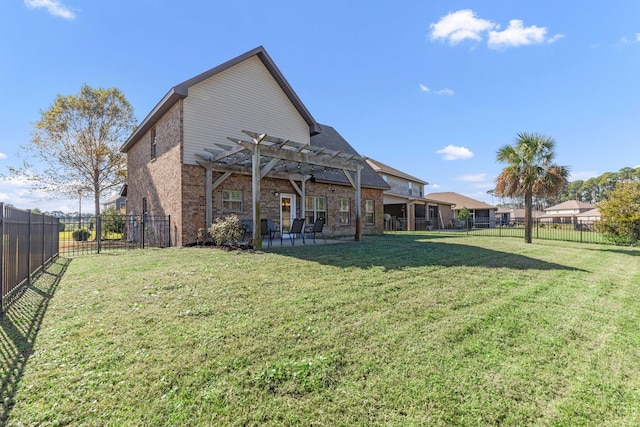 rear view of property with a pergola, a patio, and a lawn