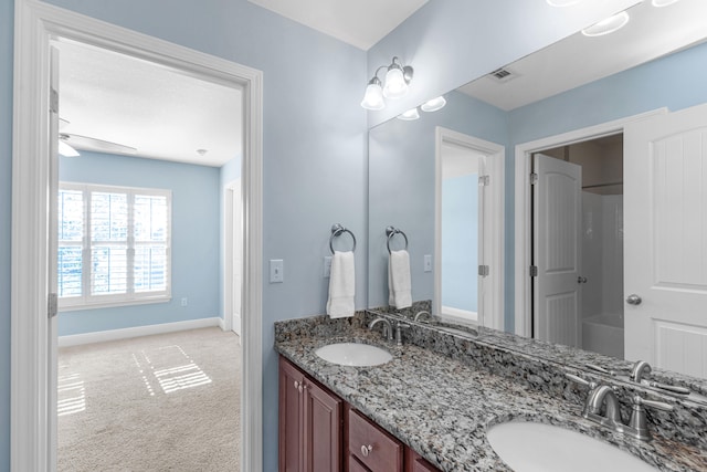 bathroom with ceiling fan and vanity