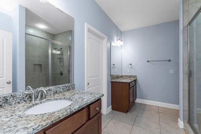 bathroom with tile patterned flooring, vanity, and a shower with shower door