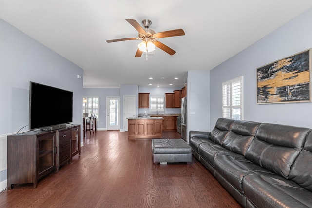 living room with ceiling fan and dark wood-type flooring