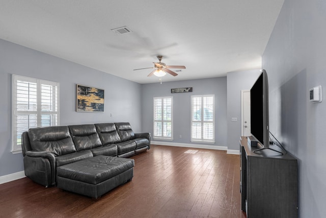 living room with dark hardwood / wood-style floors and ceiling fan