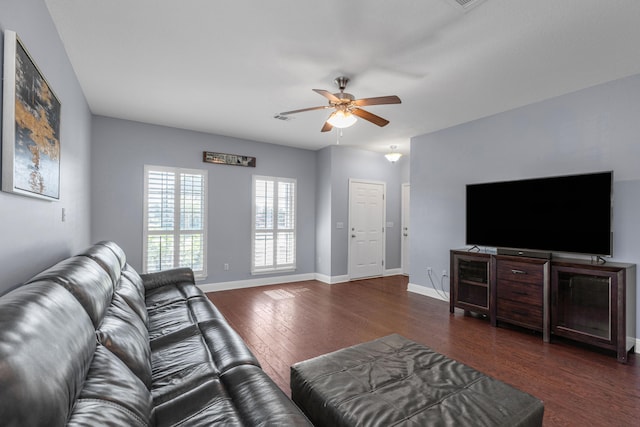 living room featuring ceiling fan and dark hardwood / wood-style flooring