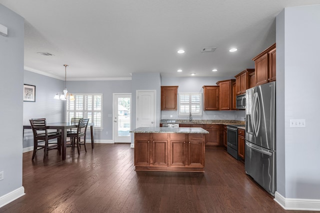 kitchen featuring dark hardwood / wood-style flooring, plenty of natural light, a kitchen island, and stainless steel appliances