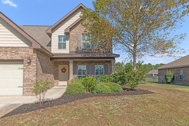 view of front of property featuring a front yard and a garage