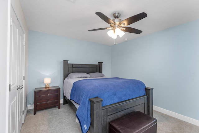 bedroom with light carpet and ceiling fan