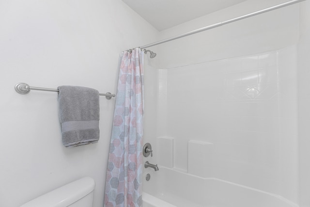 bathroom featuring shower / bath combo and toilet