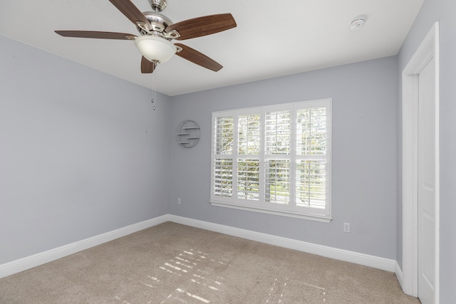 carpeted spare room with ceiling fan