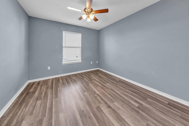 spare room featuring ceiling fan, hardwood / wood-style floors, and a textured ceiling