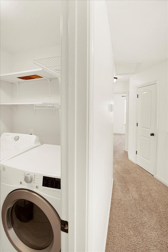 laundry area featuring light carpet