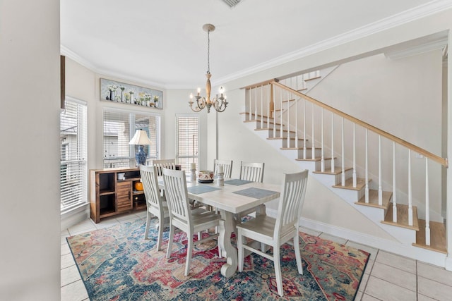 tiled dining space featuring crown molding and a notable chandelier