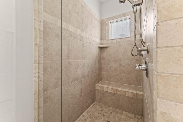 bathroom with tiled shower