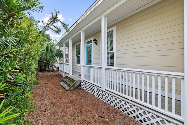 view of side of home with covered porch