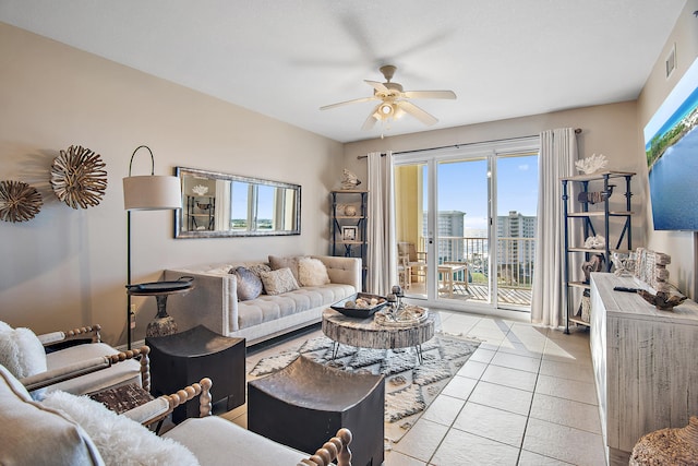 living room featuring ceiling fan and light tile patterned flooring