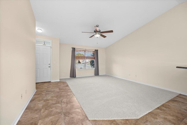 interior space with ceiling fan, light carpet, and vaulted ceiling