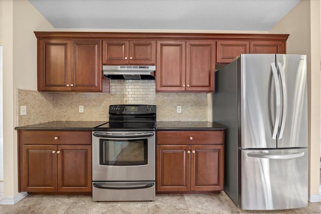 kitchen with dark stone countertops, stainless steel appliances, and tasteful backsplash