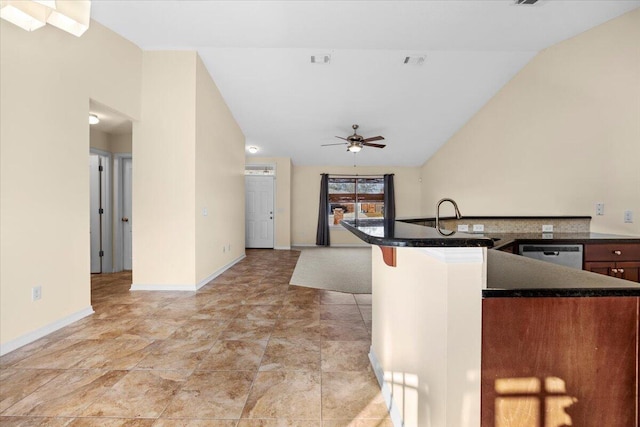 kitchen with ceiling fan, sink, a kitchen breakfast bar, vaulted ceiling, and dishwashing machine