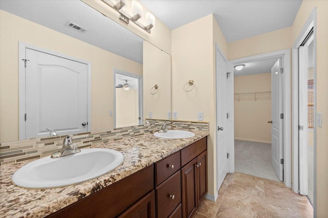 bathroom with tasteful backsplash, ceiling fan, and vanity