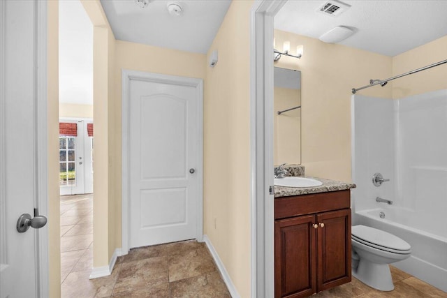 full bathroom with toilet, vanity, and washtub / shower combination