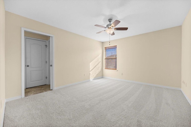 carpeted empty room featuring ceiling fan