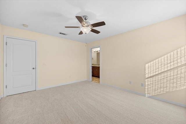 carpeted spare room with ceiling fan