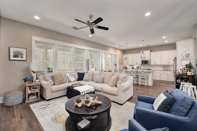 living room featuring light wood-type flooring and ceiling fan