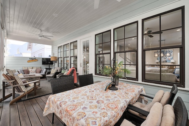 sunroom featuring ceiling fan and wooden ceiling