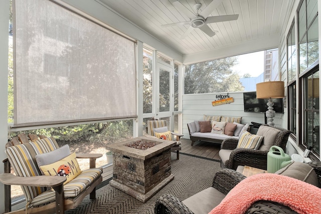 sunroom featuring ceiling fan and wooden ceiling