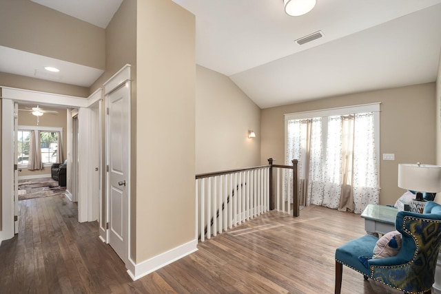 hallway with dark hardwood / wood-style flooring and lofted ceiling