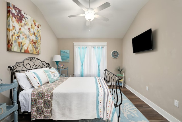 bedroom with vaulted ceiling, ceiling fan, and dark wood-type flooring