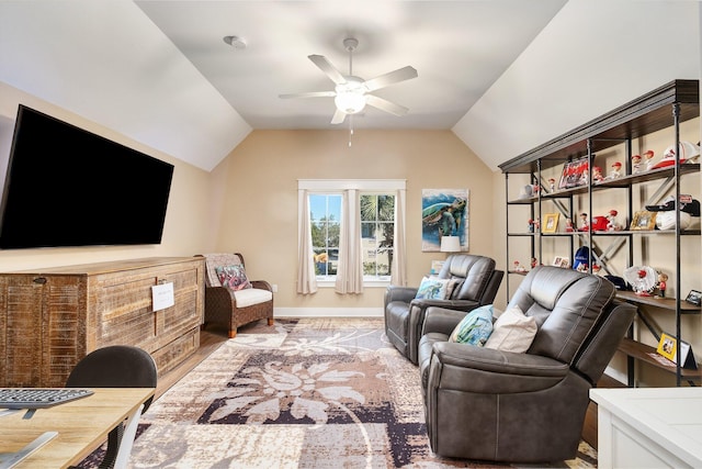 living room featuring hardwood / wood-style flooring, vaulted ceiling, and ceiling fan