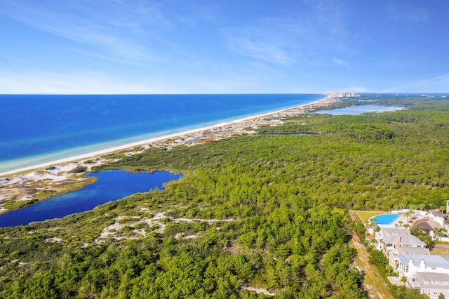 birds eye view of property with a water view and a view of the beach