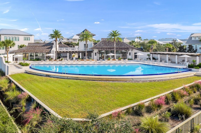 view of swimming pool with a yard and a patio