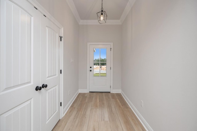 doorway to outside featuring ornamental molding, baseboards, and light wood finished floors