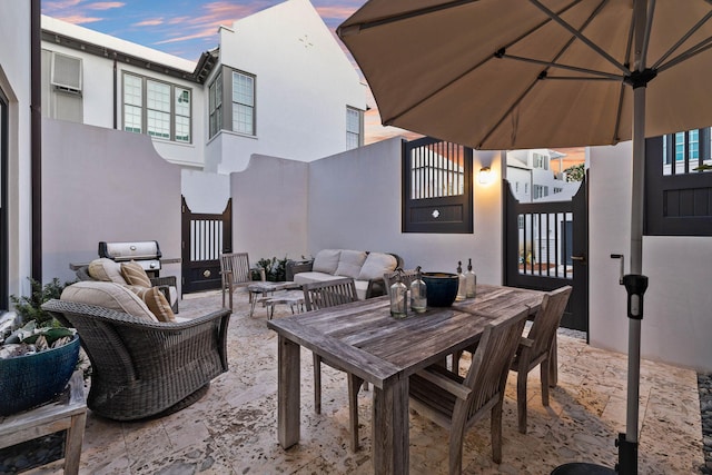 patio terrace at dusk featuring outdoor lounge area