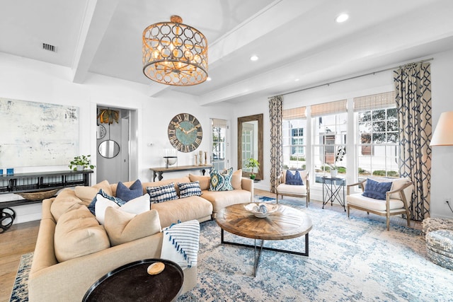 living room featuring beam ceiling, a notable chandelier, and hardwood / wood-style floors