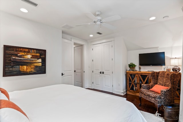 bedroom with ceiling fan, a closet, and dark hardwood / wood-style floors