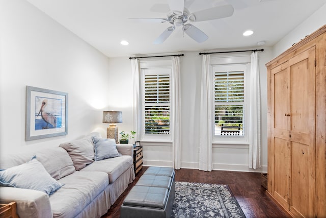 living room featuring ceiling fan and dark wood-type flooring