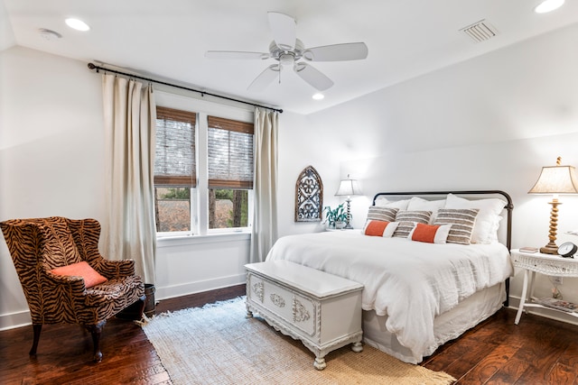 bedroom with ceiling fan, dark wood-type flooring, and vaulted ceiling