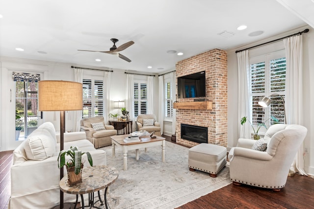 living room featuring a fireplace, hardwood / wood-style floors, plenty of natural light, and ceiling fan