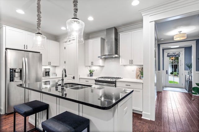 kitchen with a kitchen island with sink, white cabinets, wall chimney range hood, dark hardwood / wood-style floors, and stainless steel appliances