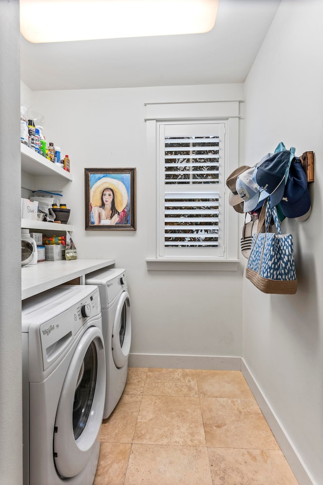 laundry room with washer and clothes dryer and light tile patterned floors