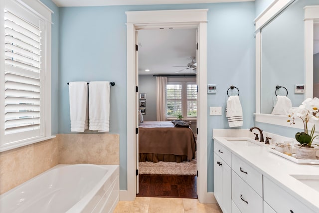 bathroom featuring tile patterned floors, a bathing tub, ceiling fan, and vanity