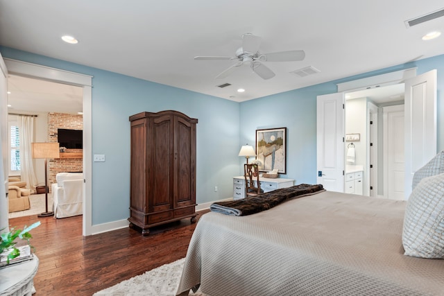 bedroom featuring ceiling fan, dark wood-type flooring, and ensuite bath