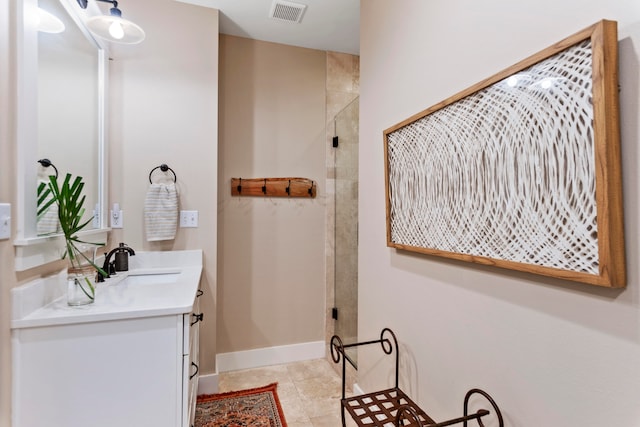 bathroom with tile patterned flooring, vanity, and an enclosed shower