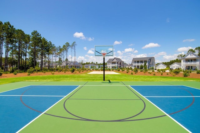 view of sport court with a yard