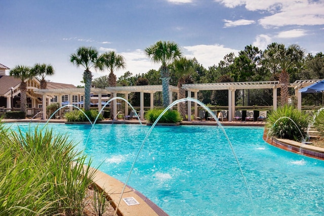 view of swimming pool with pool water feature and a pergola