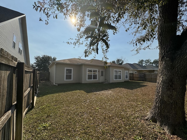 back of property featuring a yard