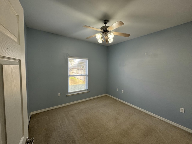 carpeted spare room with ceiling fan