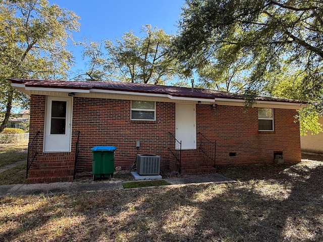 back of property featuring central AC