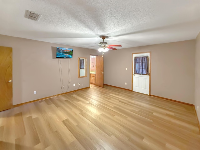 unfurnished room featuring ceiling fan, a textured ceiling, and light wood-type flooring